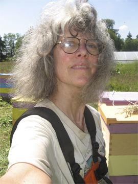 Beekeeper in Tee-Shirt while cutting grass at hives